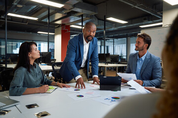 Wall Mural - Group of multiracial business people in businesswear talking and gesturing during meeting in office