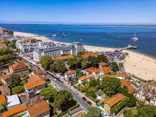 The drone aerial view of the beach and the city of Arcachon, France. Arcachon is a commune in the southwestern French department of Gironde. It is a popular seaside resort on the Atlantic coast.