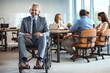 © Dragana Gordic - Confident Businessman in Wheelchair Leading Office Meeting