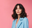 © DariaTrofimova - Portrait of a young girl with wavy hair in a blue jacket on a pink background