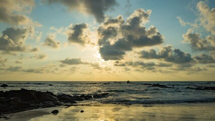 Wall Mural - Timelapse of dramatic sunset with orange sky in a cloudy day at the ocean.