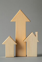 Three wooden arrows pointing upwards in the shape of houses, on a gray background, representing house value growth.