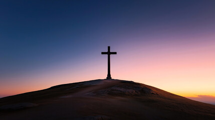 Poster - Silhouette of a large cross atop a hill at sunset, with a vibrant gradient sky from dark blue to warm orange hues, creating a serene and peaceful atmosphere