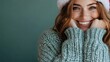 © Maximages  - A woman with bright smile, wearing a cozy green sweater and Santa hat, exudes warmth and holiday cheer against a green backdrop, perfect for festive occasions.