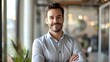 © pkproject - Confident businessman smiling in modern office environment