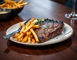 © kengkreingkrai - there is a steak and french fries on a plate on a table.