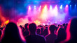 © MCGORIE - Blurred background of an open-air concert with people in the foreground, with stage lights and musical instruments visible.