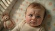 © gn8 - Newborn Baby with Tearful Expression Lying in Crib Next to Plush Toy Emotional Infant Portrait for Stock Photography