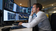 © Kiangdeb - Financial analyst monitors stock market data on multiple screens, analyzing charts and graphs in a busy office environment