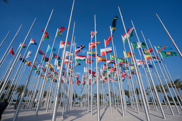 Wall Mural - Various flags of the world against the blue sky.