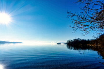 Looking over the lake Starnberg with the Alps in the background and a blue overall impression.