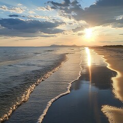 Sticker - Sunset over a sandy beach with ocean waves rolling in.