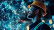 © pornthip - Industrial Worker Looking at Digital Network Visualization