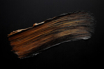 Wall Mural - bright brown brush stroke of paint on black background