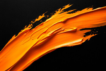 Wall Mural - bright orange brush stroke of paint on black background