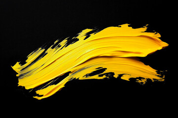 Wall Mural - bright yellow brush stroke of paint on black background