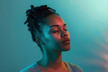 Serene woman in soft blue and green lighting