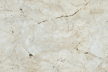 Textured limestone marble surface featuring cracks and a light beige color. The surface has a natural, elegant appearance, suitable for backgrounds or design elements.