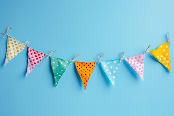 A colorful banner with polka dots hangs on a blue background