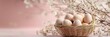 © Sanwa - A basket of eggs nestled amongst delicate white blossoms on a soft pink backdrop. The image symbolizes new beginnings, spring, fertility, and the joy of Easter.
