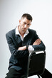 © Elina Leonova - Handsome man, fashion model sits on chair