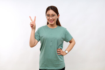 Smiling happy good-looking asian girl giving advice, showing two fingers as explain rules, make point, standing white background