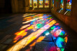 © kashiStock - a stained glass window in an old cathedral, with the sunlight casting colorful reflections on the stone floor