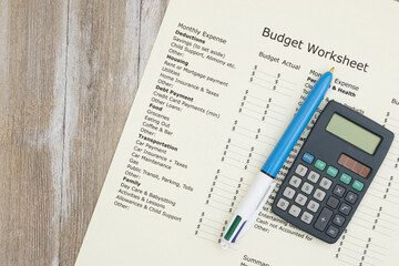 Wall Mural - Monthly personal budget with a pen and calculator on wood desk