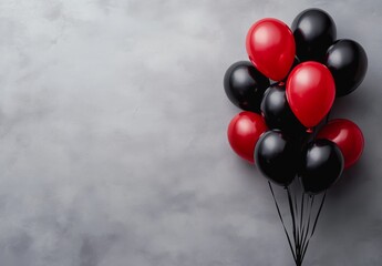 Wall Mural - Colorful red and black balloons tied together against a textured gray background for celebrations