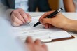 © alisaaa - Signing a contract or agreement for an investment at a business meeting. Closeup of hands filling in a form or legal document for a financial partnership inside an office by a sales employee Signing a