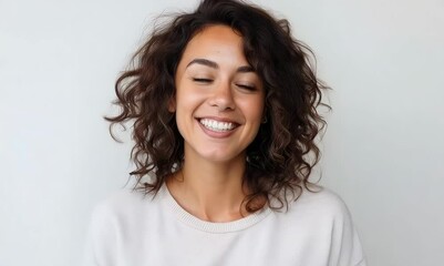 Wall Mural - Portrait of a smiling young woman with curly hair isolated on a white background