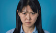 © Miklos - A young woman with dark hair stares intently into the camera with a furrowed brow
