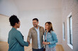 © Drazen - Happy couple greeting real estate agent while buying new house.