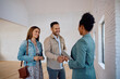 © Drazen - Happy real estate buyers shaking hands with black female agent during open house day.