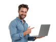 © NASSRI - Smiling man holding and pointing at laptop on transparent background, professional young businessman or student work on PC computer for startup digital marketing entrepreneur success ad banner