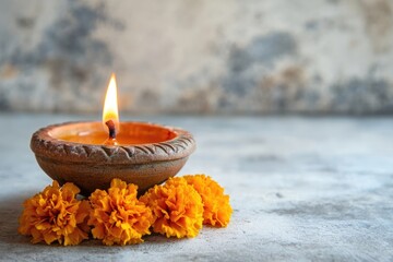 Wall Mural - Diya lamp with marigold flowers on a grunge white background, Diwali celebration