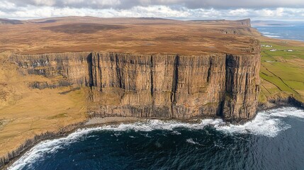 Canvas Print -   An aerial view of a cliff with a large body of water in the background and a smaller body of water in the foreground