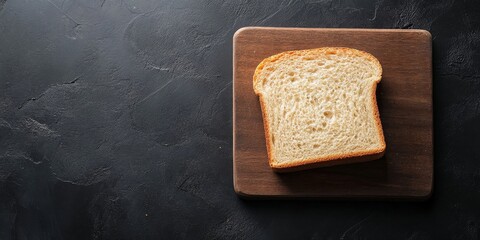 Freshly baked bread sliced on a rustic wooden board with a knife at a kitchen countertop