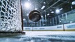 © Bonsales - Black ice hockey puck in motion towards an empty net on ice rink surface with hockey arena in the background