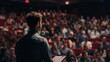 © Marco - man giving a speech in a packed auditorium
