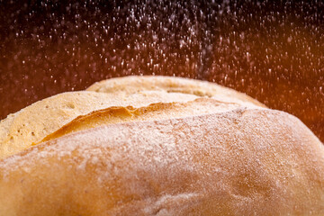 CLOSE-UP OF CARIOQUINHA BREAD WITH FLOUR  SPRINKLED ON TOP