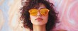 © cac_tus - Woman with curly hair wearing orange sunglasses against colorful background