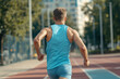 © Dar1930 - male athlete runs in the city. AI generative.