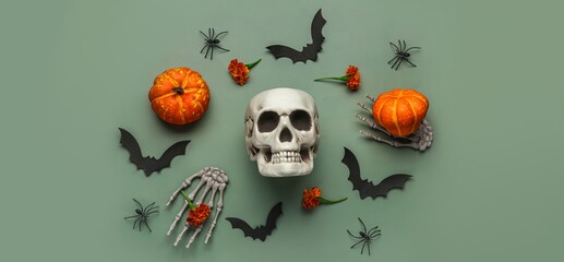 Wall Mural - Halloween composition with skull, bats, spiders and pumpkins on green background