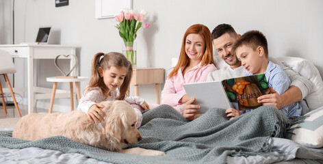 Poster - Happy family with dog reading book in bedroom at home