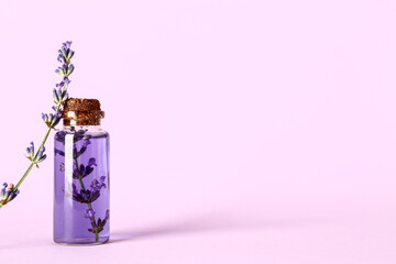 Wall Mural - Bottle of lavender essential oil on lilac background