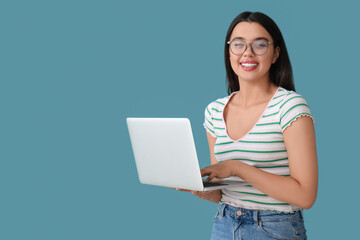 Sticker - Happy female programmer working with laptop on blue background