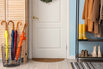 Wall Mural - Interior of hallway with door, umbrellas and folding screen