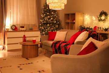 Canvas Print - Interior of cozy living room with sofa and Christmas tree decorated for holiday at night