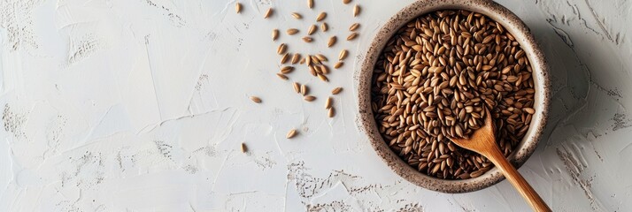 Canvas Print - Aerial perspective of a wooden spoon in a bowl of raw rye grains on a light surface. Low gluten seeds serve as a nutritious protein source for vegan and vegetarian diets.